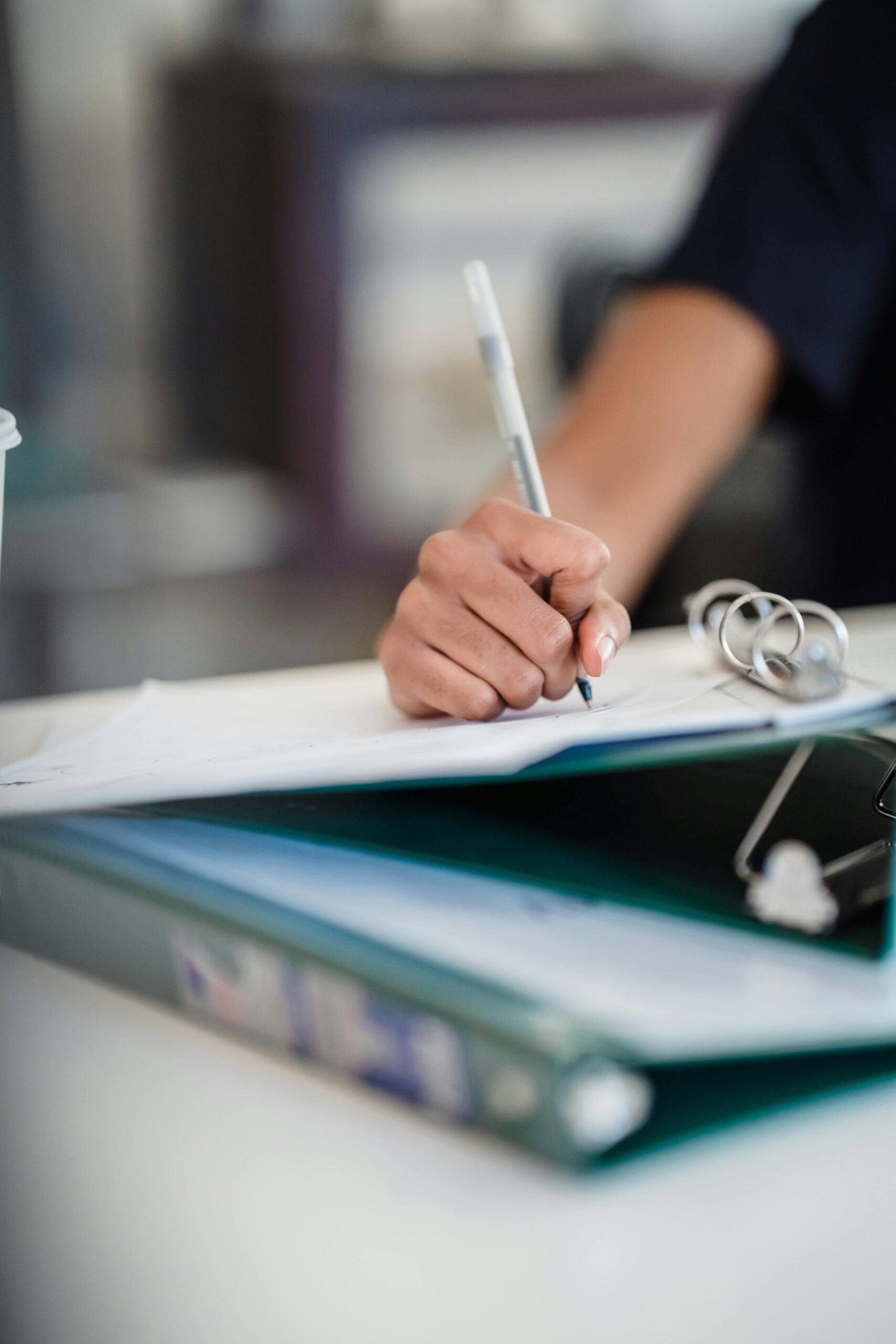 Morocco Focused image of a businesswoman writing notes in a professional office setting.