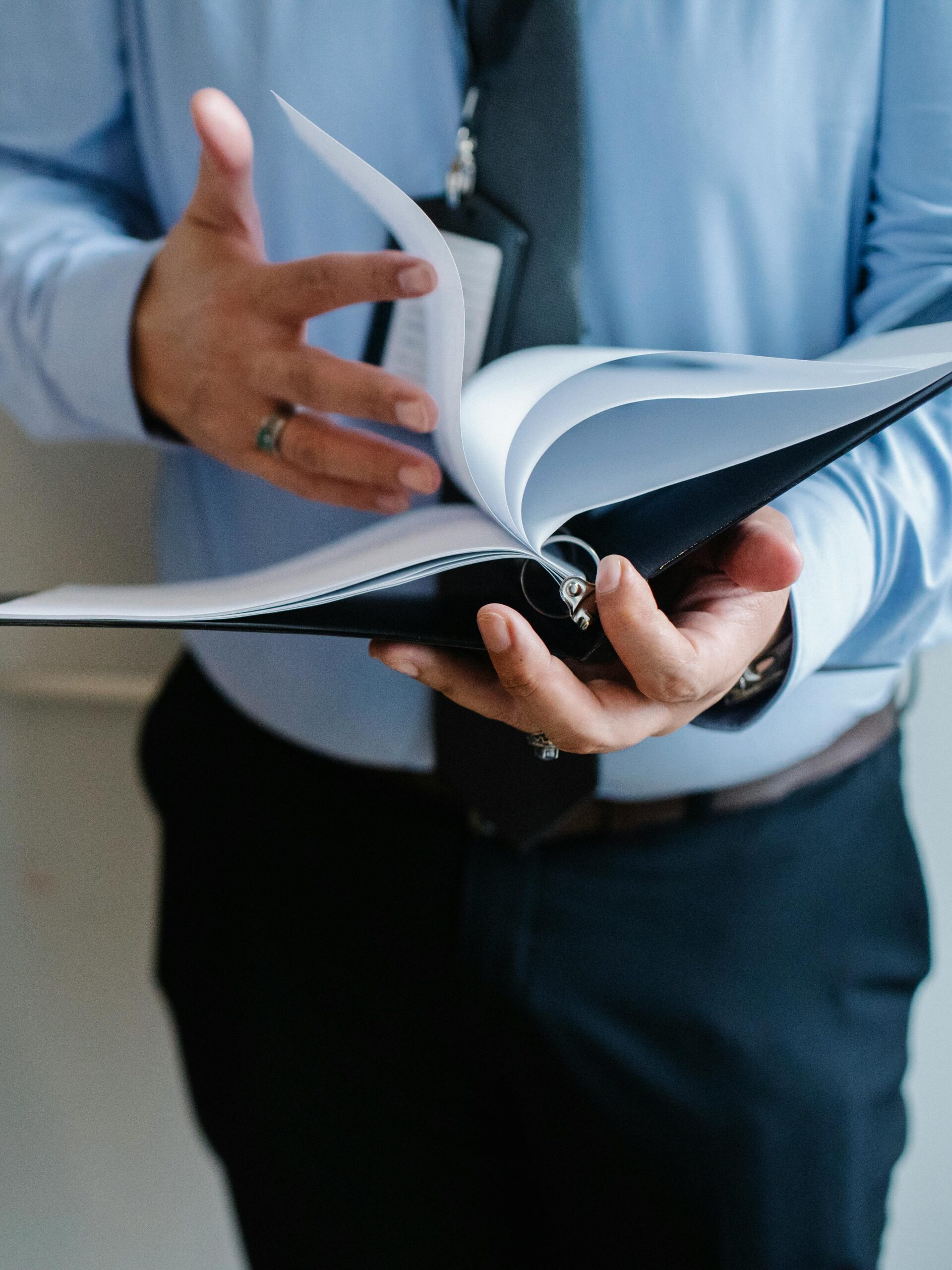 Morocco A business professional in a suit flips through documents indoors, emphasizing formal work settings.
