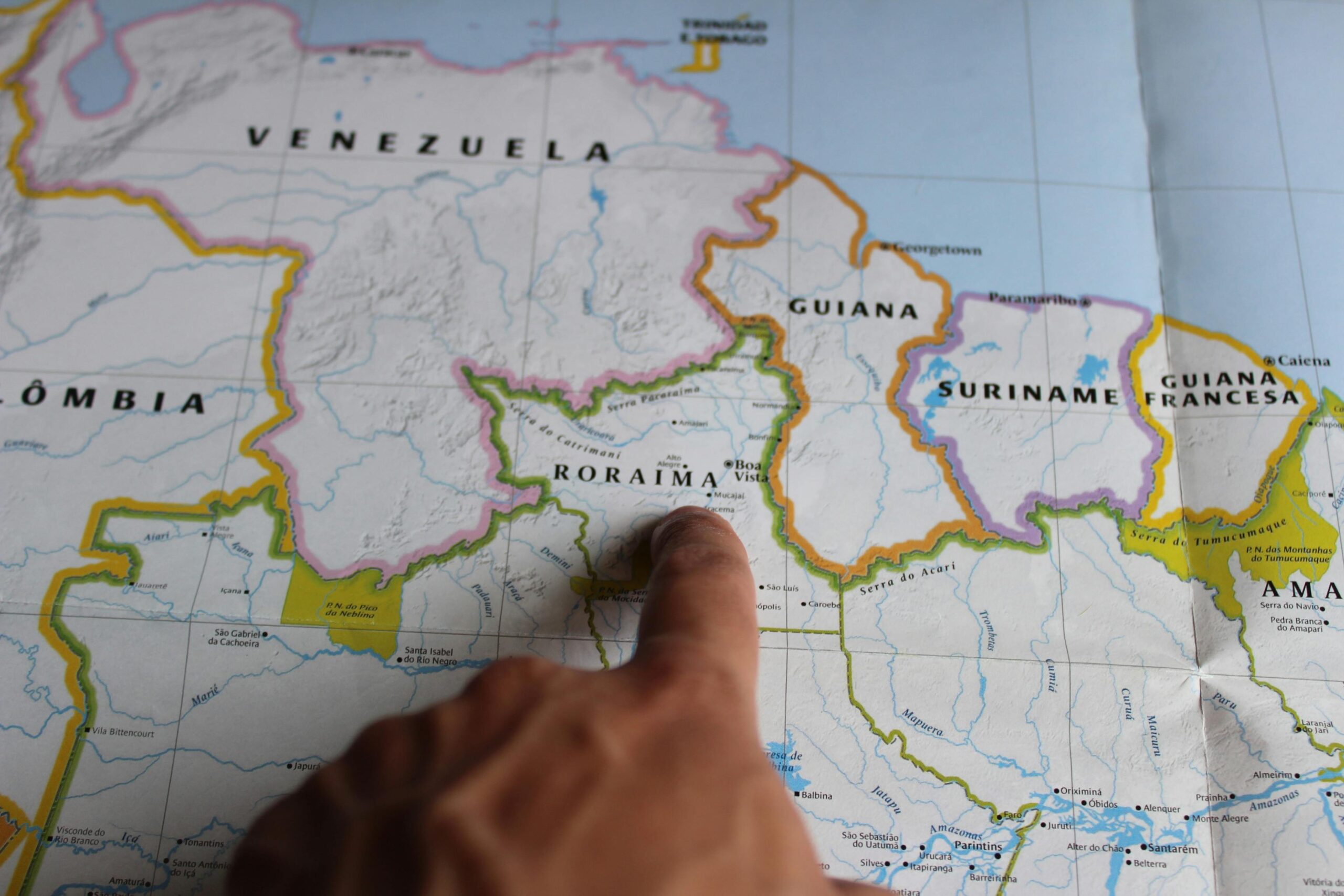 Discover Roraima, Brazil with a finger pointing on a detailed map.