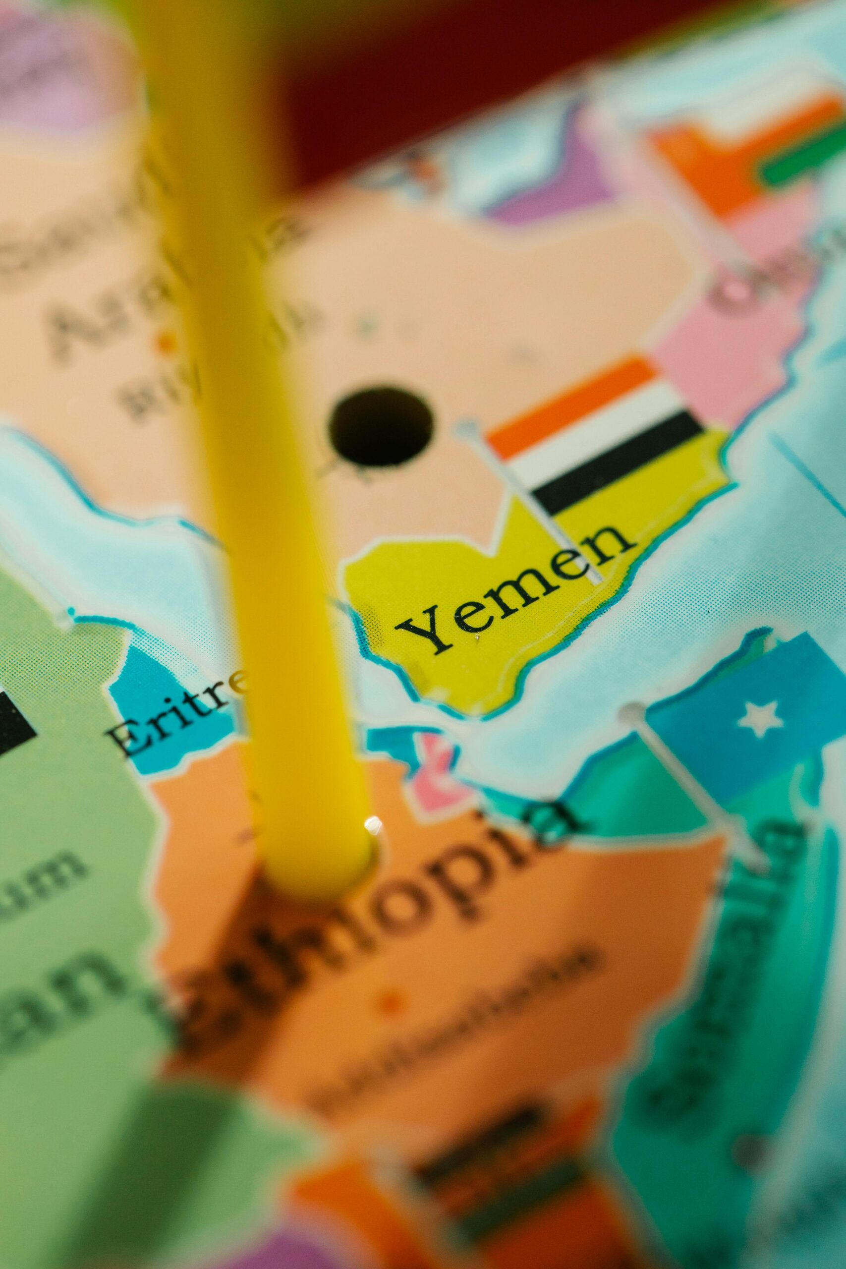An extreme close-up of a map focusing on Yemen, marked with a pin.